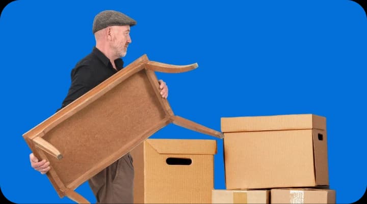 Giant Van crew delivering a dining table to a ground-floor UK home.