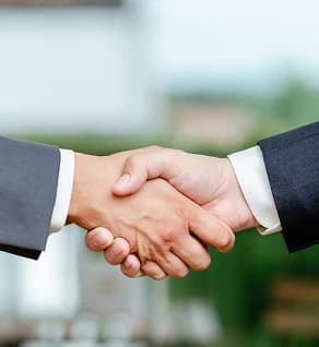 Two people shaking hands — symbol of insured, professional service.