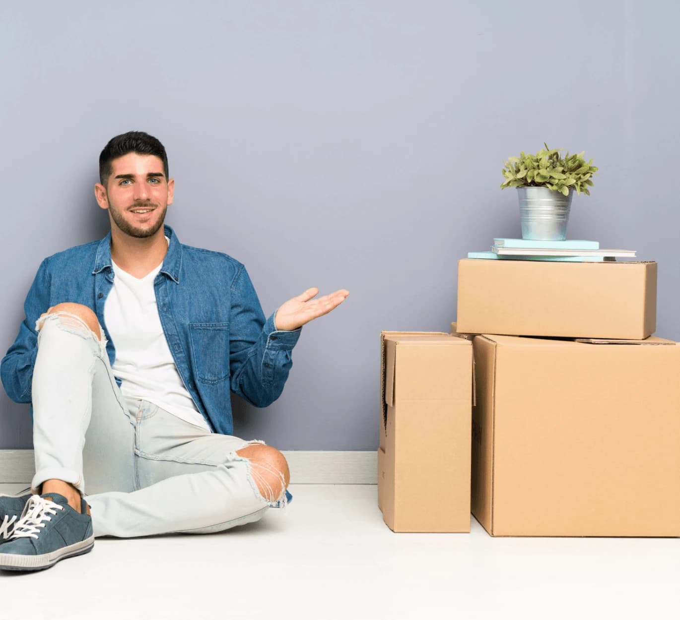 Person planning a house move with packing boxes