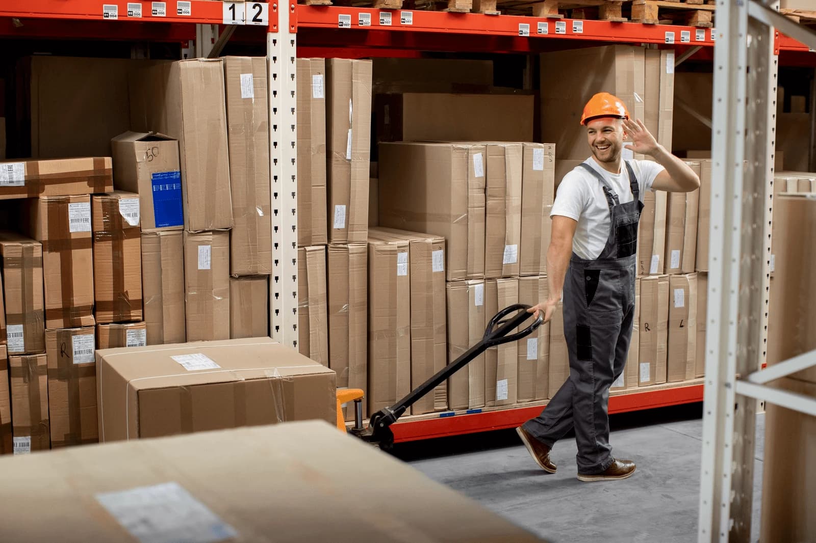 Warehouse operative moving palletised stock during a phased relocation