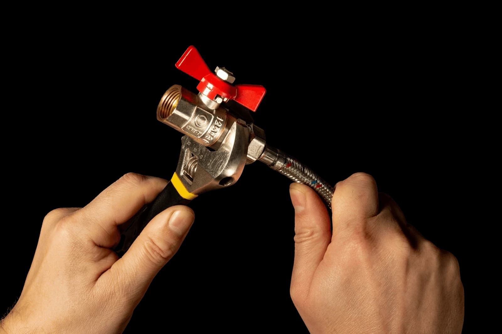 Hands disconnecting a washing machine water valve before collection