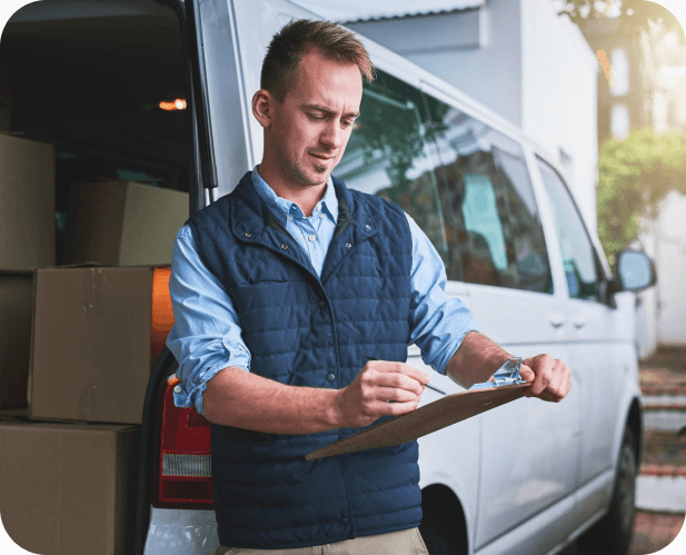 Giant Van business account manager with clipboard by a removals van