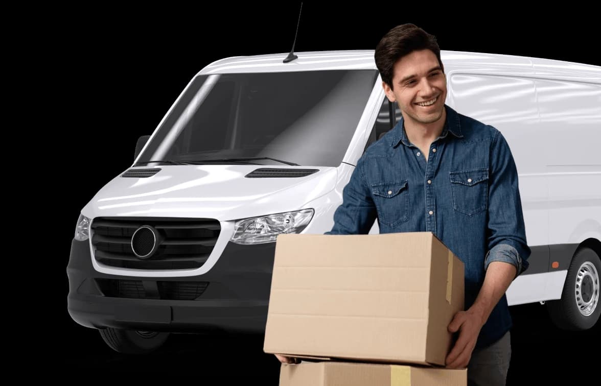 Giant Van team member smiling while carrying a moving box