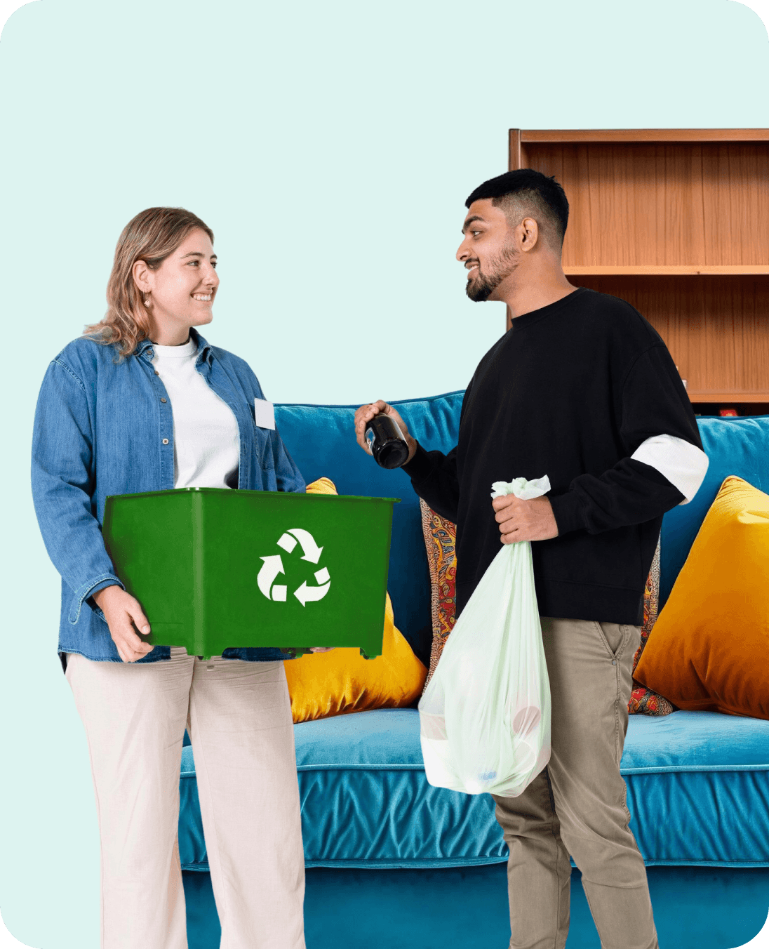 Two colleagues handing over a green recycling box during an office clearance