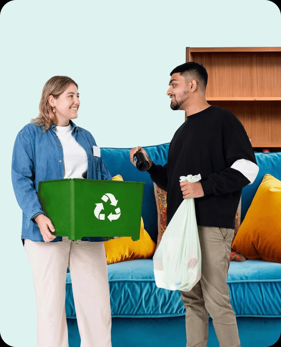 Two colleagues handing over a green recycling box during an office clearance