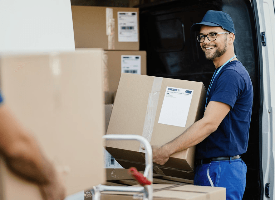 Porters loading a hired van the customer has arranged