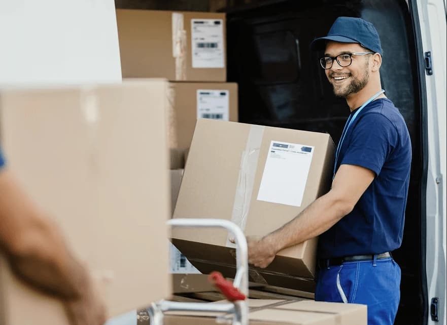 Porters loading a hired van the customer has arranged