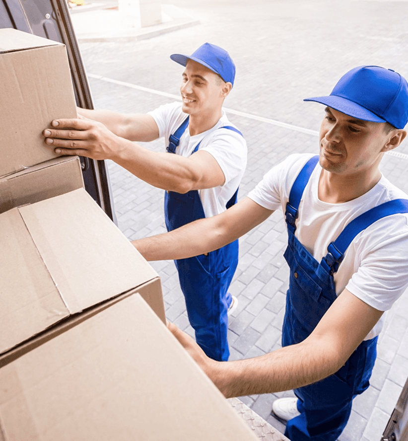 Giant Van porters loading boxes into a van with professional equipment