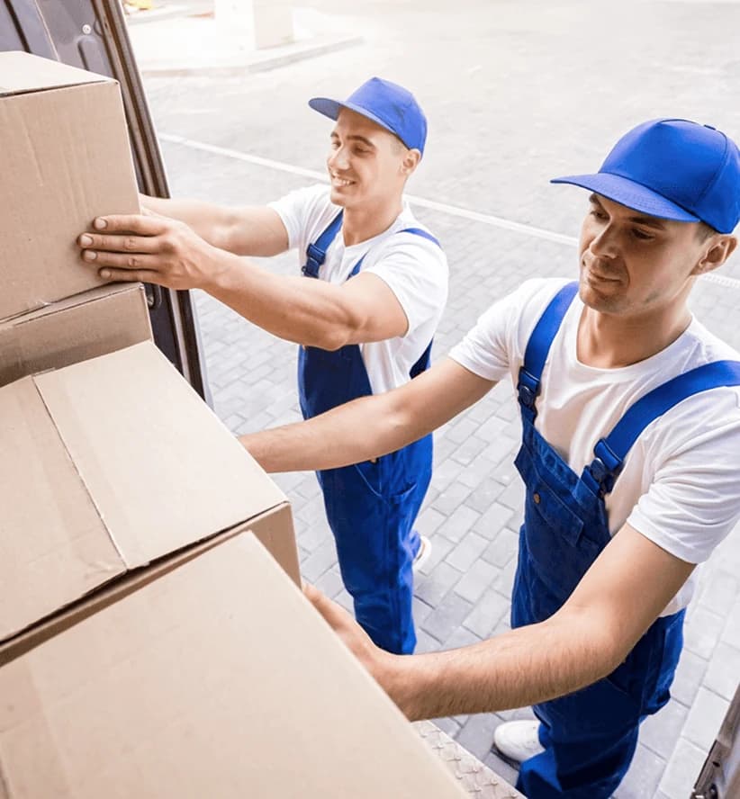 Giant Van porters loading boxes into a van with professional equipment