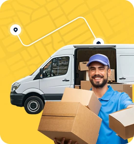 Smiling Giant Van operator holding cardboard boxes beside a loaded white van on a GPS-tracked route