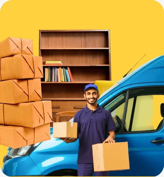 Smiling Giant Van driver in a blue polo holding cardboard boxes beside a blue van